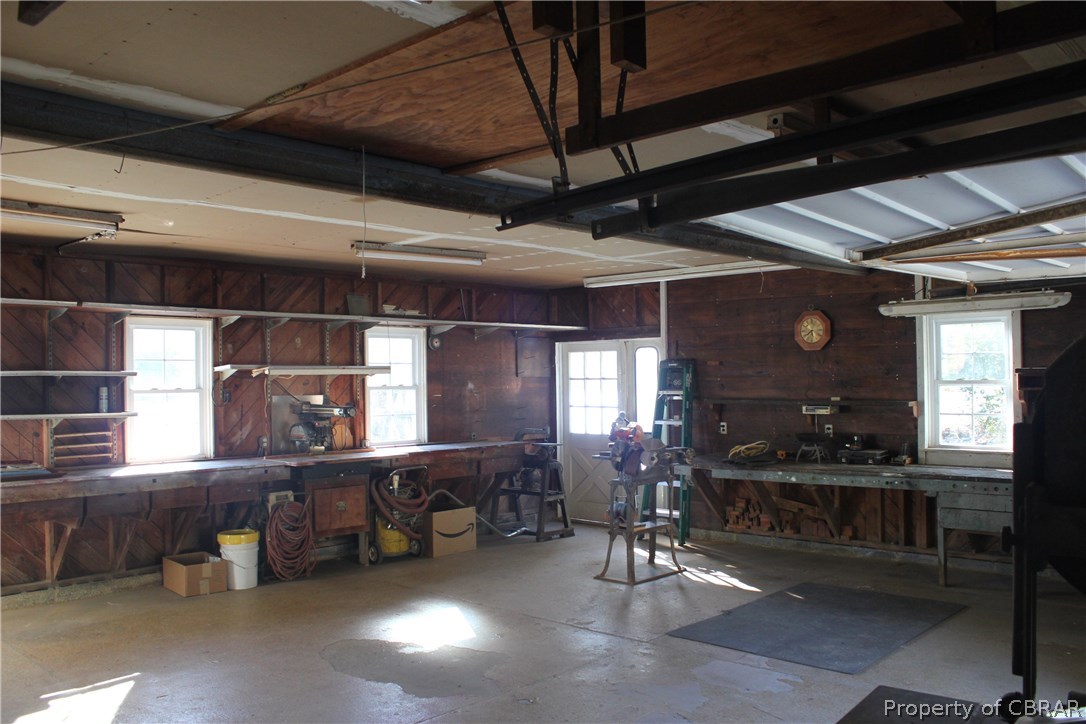 1050 Tick Neck Road Cardinal, VA 23025 - Photo 42 of 47 a room with lots of wooden furniture and windows