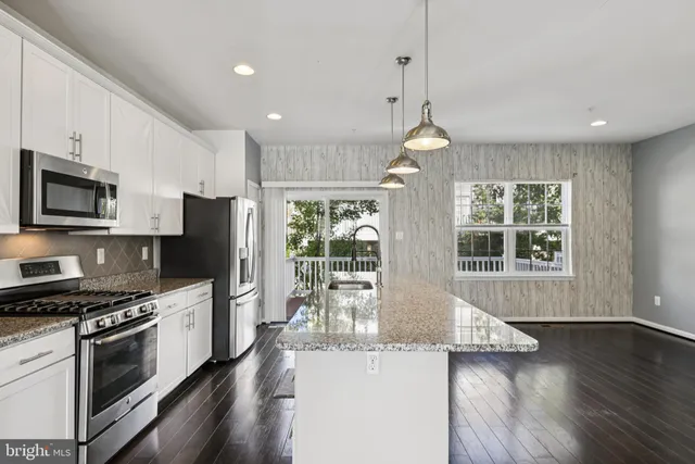a kitchen with stove and refrigerator