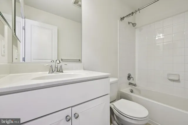a bathroom with a sink toilet vanity tub and shower