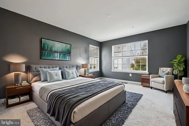 a bedroom with bed couch and window