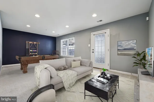 a living room with furniture and a potted plant