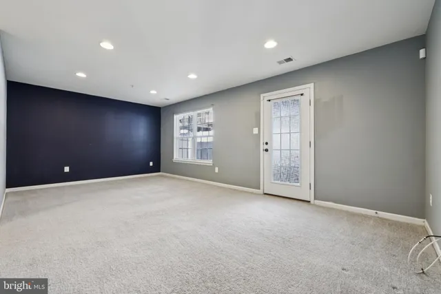 a view of an empty room with windows