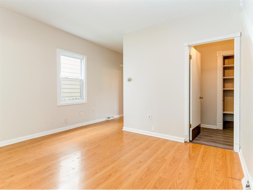 448 Park Street Rochester, PA 15074 - Photo 4 of 29 an empty room with wooden floor and closet