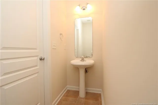 a bathroom with a sink a mirror and a shower
