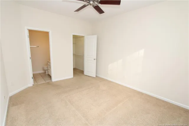 a view of a room with a ceiling fan