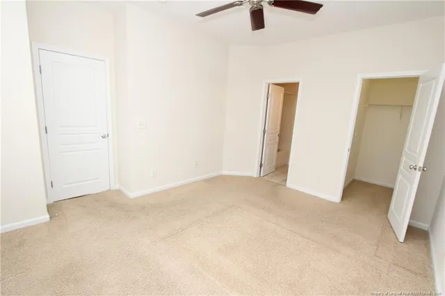 an empty room with ceiling fan