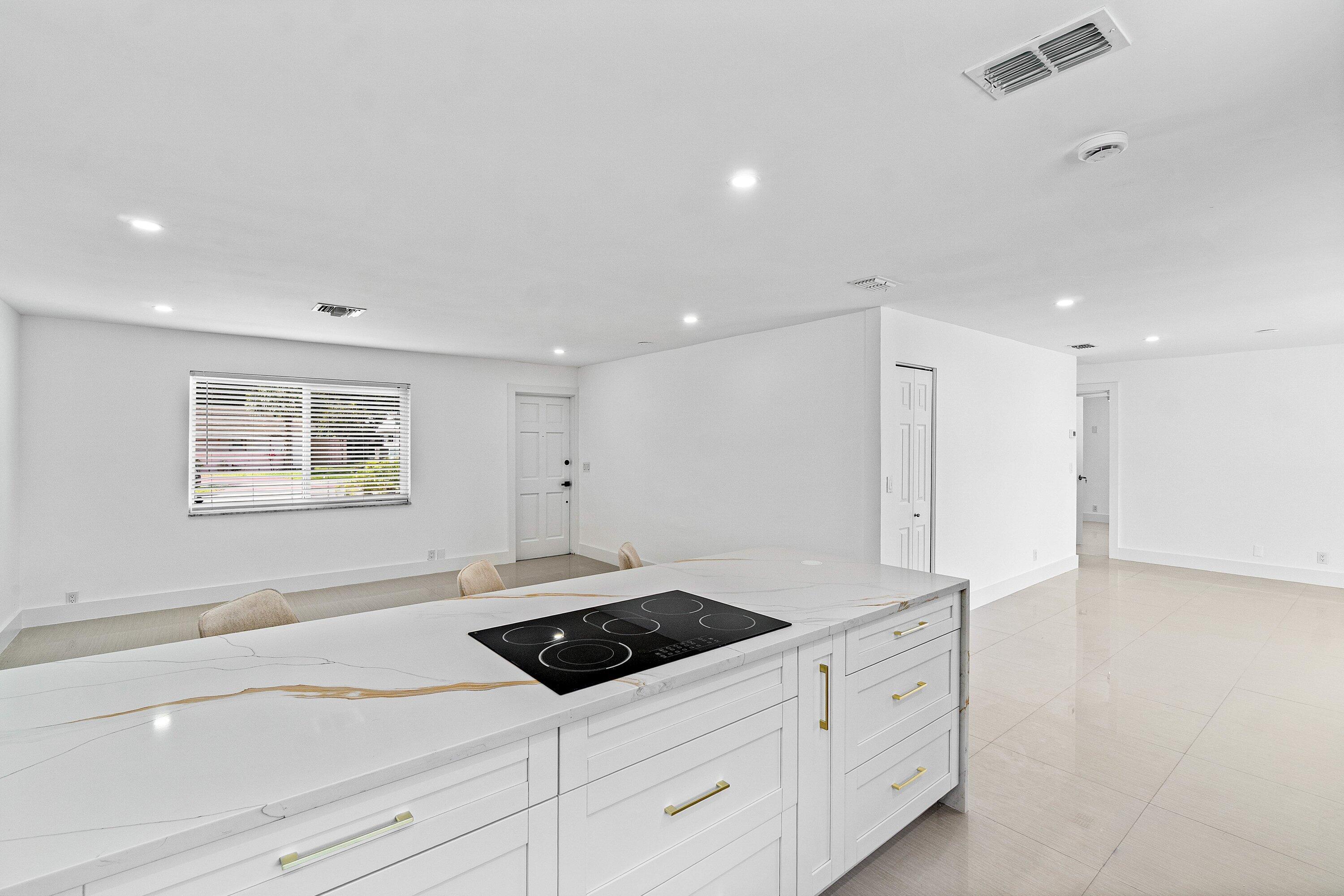 1531 Northwest 4th Street Boca Raton, FL 33486 - Photo 11 of 34 a kitchen with a sink and a refrigerator