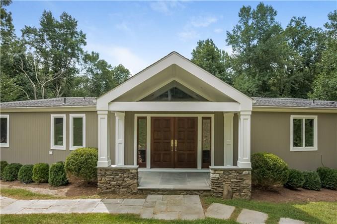 95 Pond Road Wilton, CT 06897 - Photo 1 of 1 a front view of a house with a yard