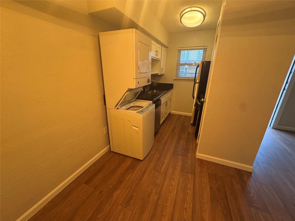 2401 Manor Road, Unit 118 Austin, TX 78722 - Photo 3 of 8 a utility room with wooden floor washer and dryer