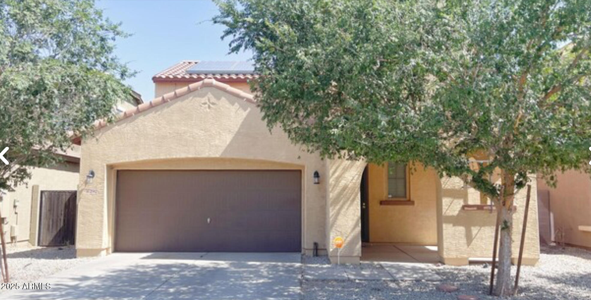 2542 West Gaby Road Phoenix, AZ 85041 - Photo 2 of 12 a house with trees in front of it