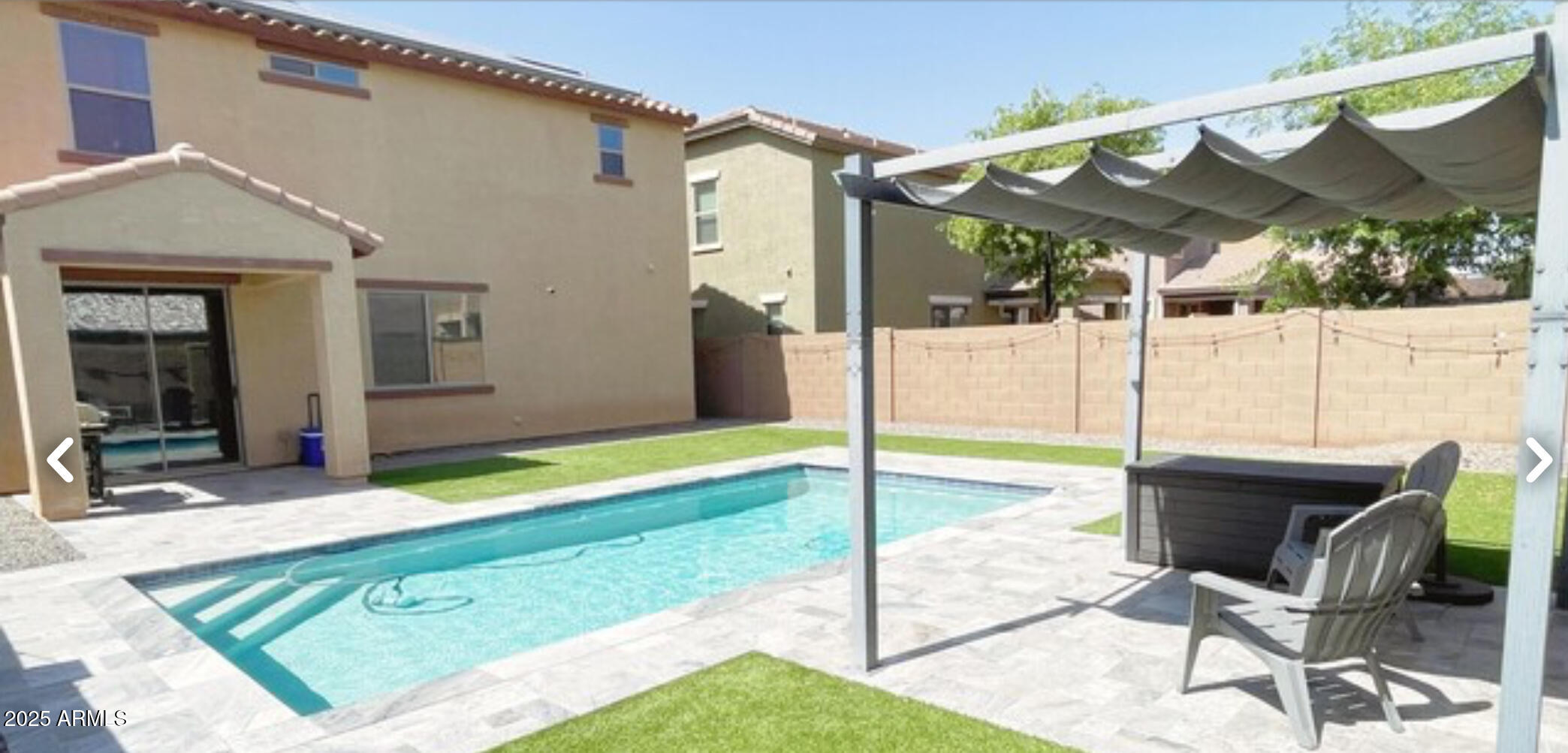 2542 West Gaby Road Phoenix, AZ 85041 - Photo 10 of 12 a view of a patio with a table and chairs under an umbrella