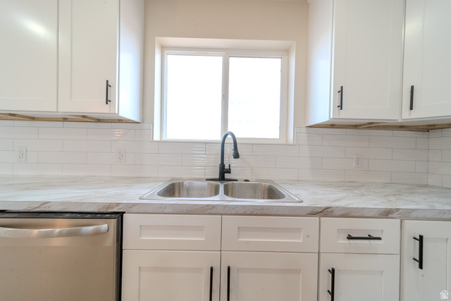 130 Pole Line Road, Unit 2 Roosevelt, UT 84066 - Photo 13 of 33 Kitchen featuring white shaker-style cabinetry, matte black hardware, dual stainless steel basin sink, a black pull-down faucet, and a white subway tile backsplash