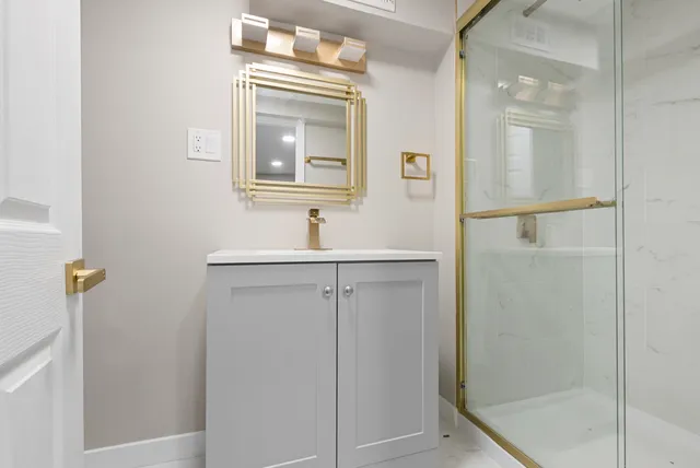 a bathroom with a shower sink and mirror