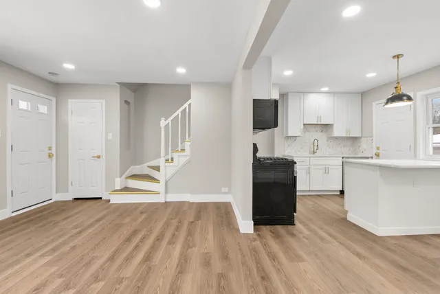 a kitchen with a refrigerator and a sink