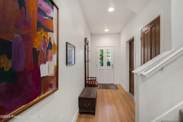 a view of a hallway with paintings on the wall