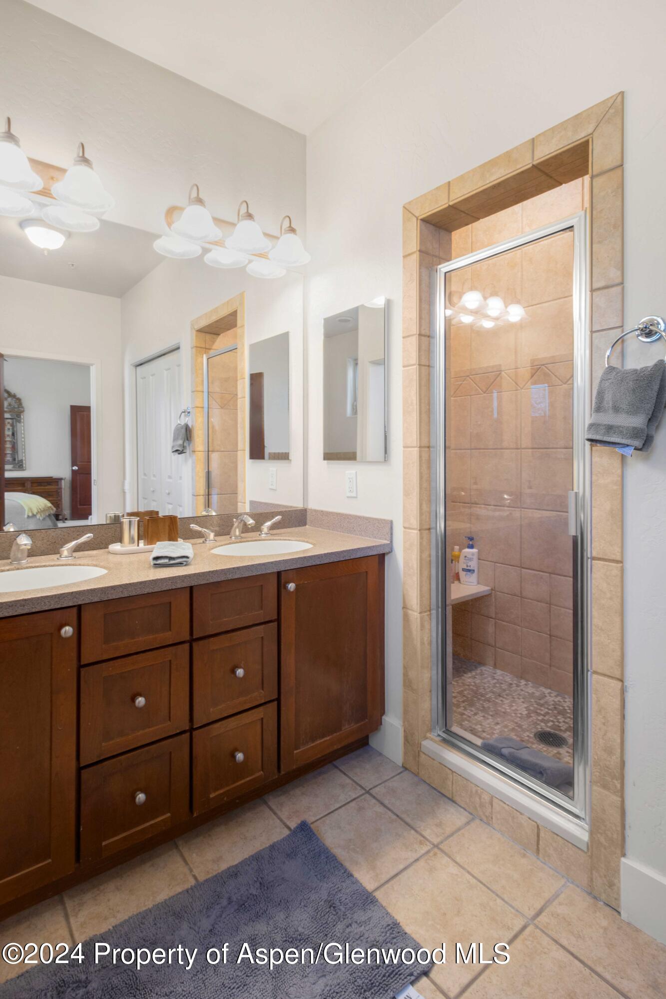 532 Evans Court Basalt, CO 81621 - Photo 20 of 22 a bathroom with a granite countertop sink mirror and shower
