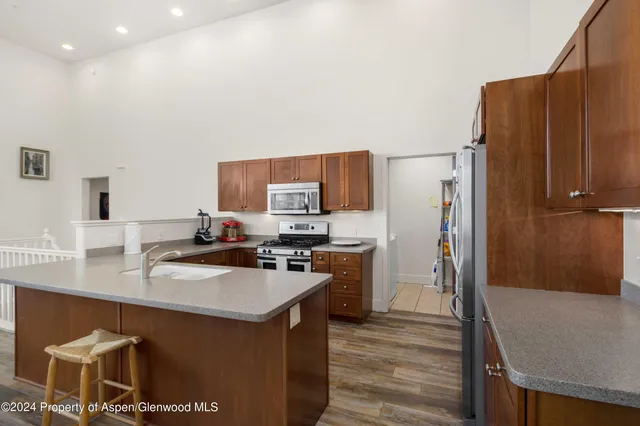a kitchen with a sink a refrigerator a stove and a cabinets