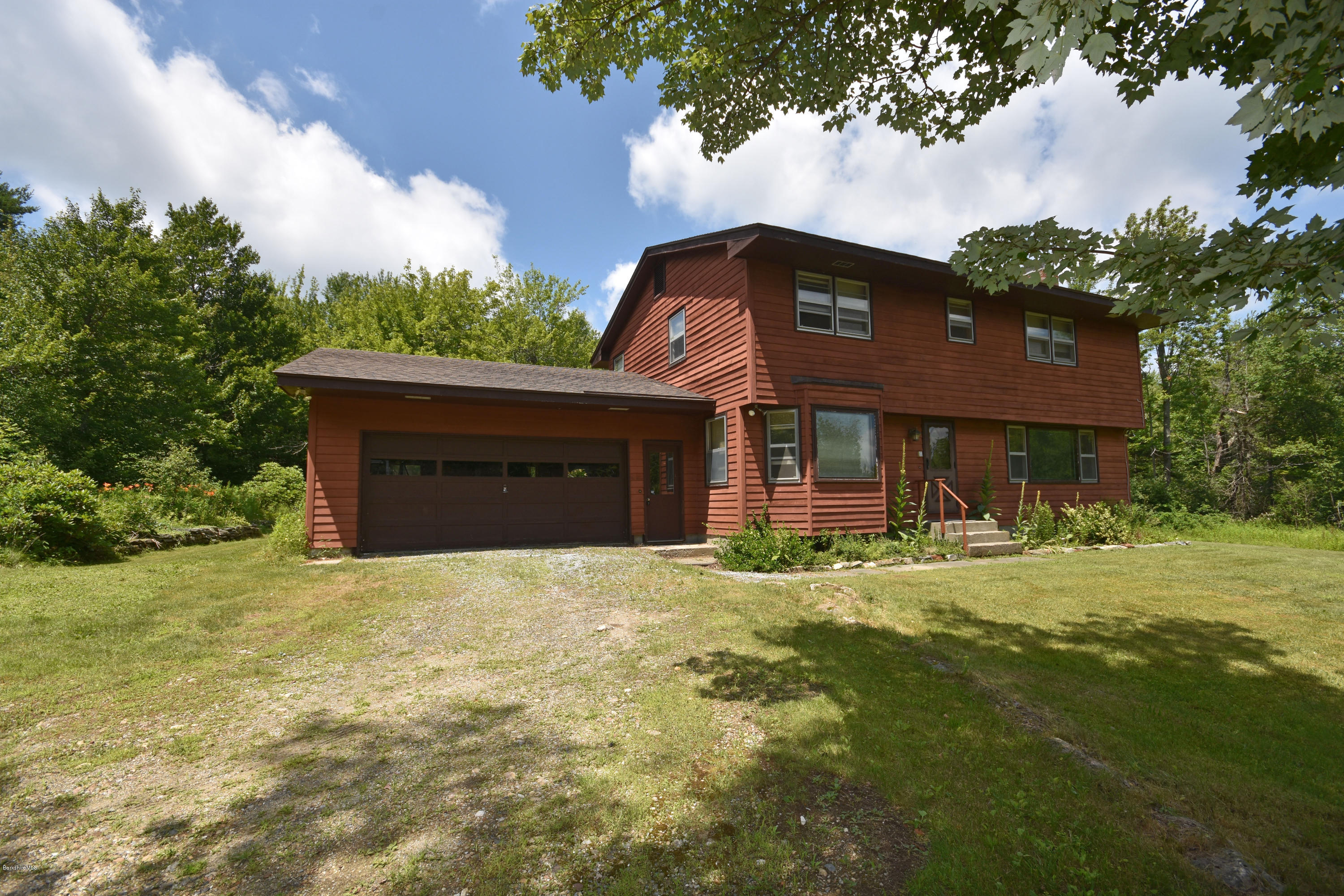 247 East Windsor Road Peru, MA 01235 - Photo 1 of 42 a front view of a house with a yard and garage