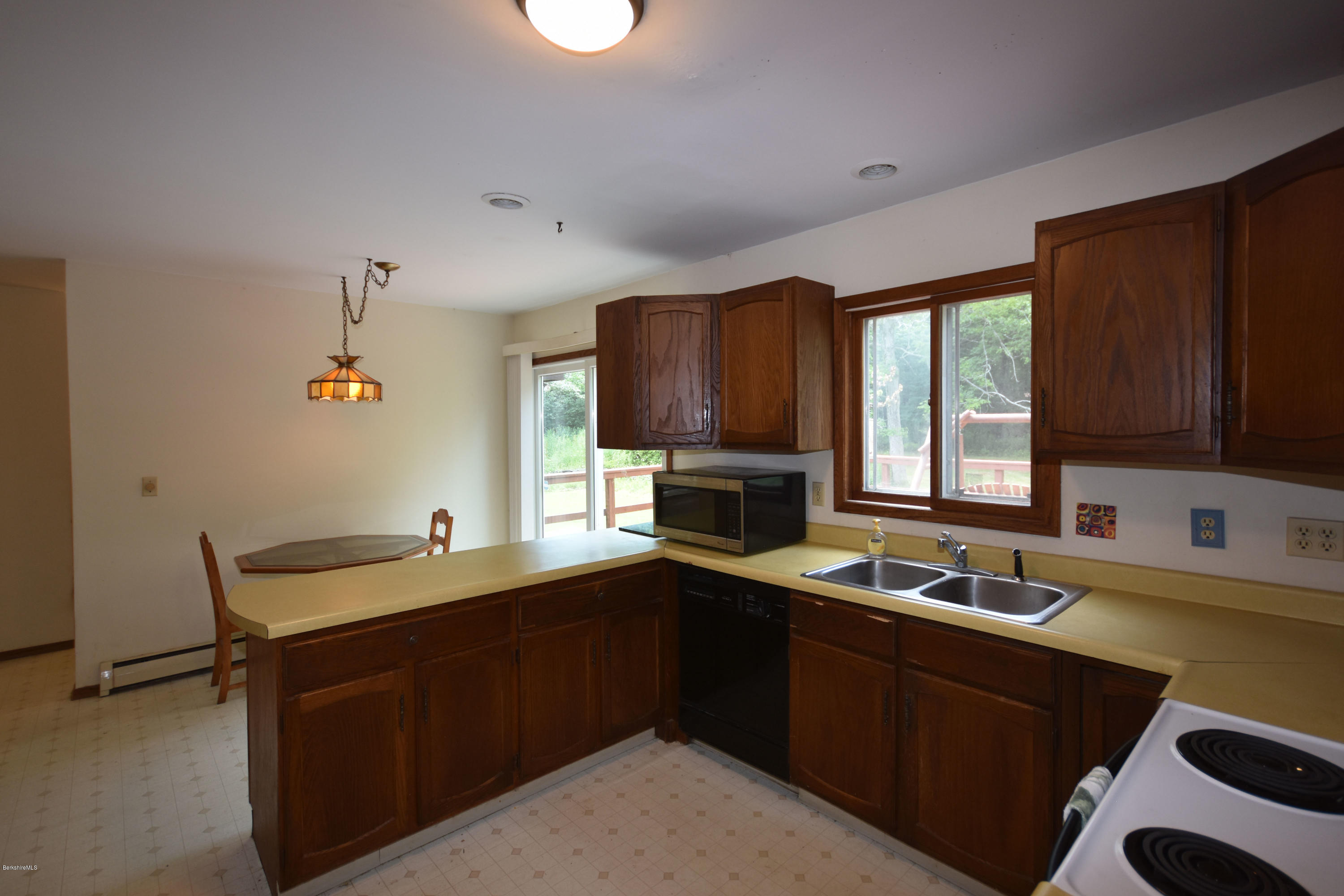 247 East Windsor Road Peru, MA 01235 - Photo 12 of 42 a kitchen with a sink and a stove top oven with wooden floor