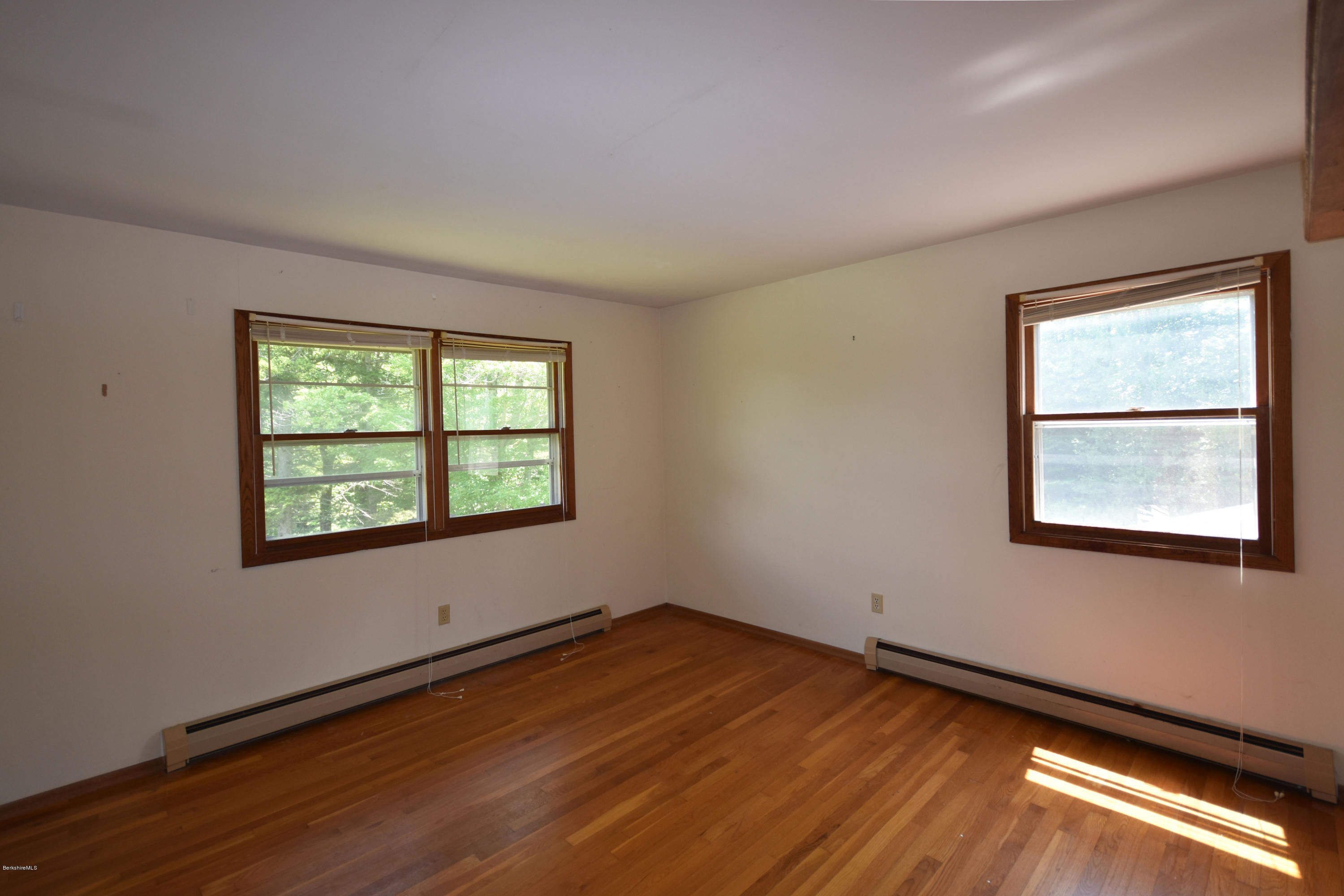 247 East Windsor Road Peru, MA 01235 - Photo 24 of 42 an empty room with wooden floor and windows