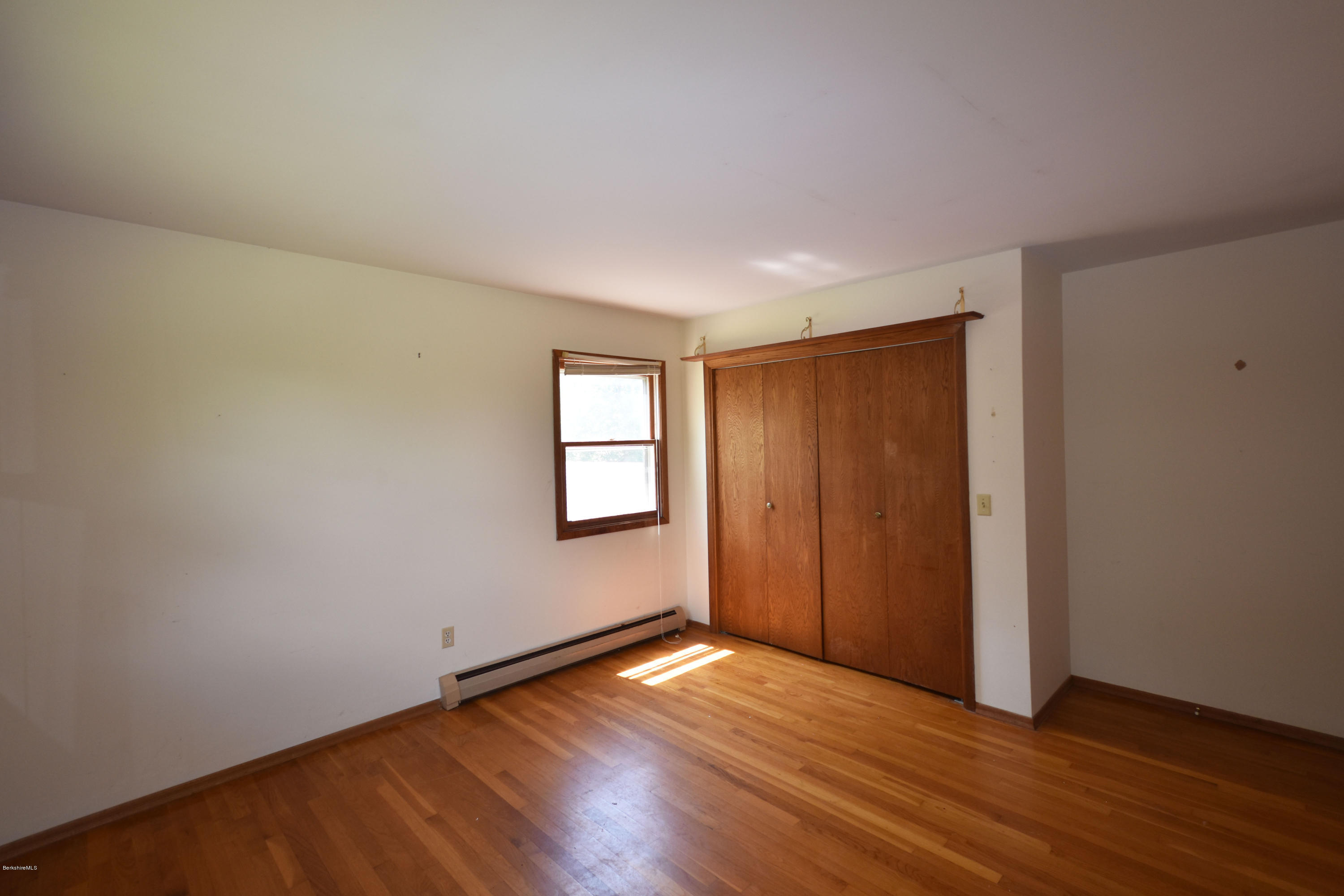 247 East Windsor Road Peru, MA 01235 - Photo 25 of 42 an empty room with wooden floor and windows