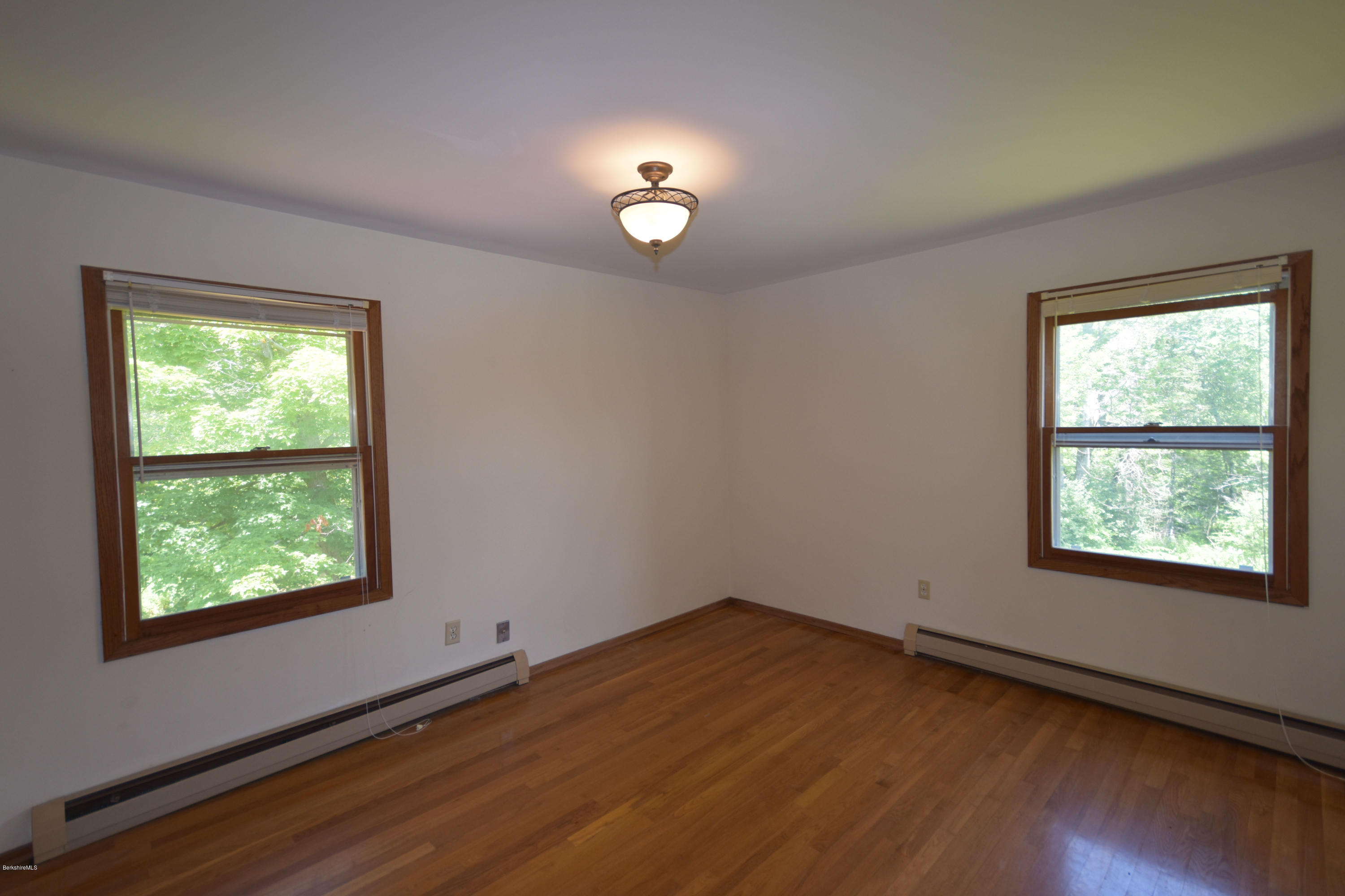 247 East Windsor Road Peru, MA 01235 - Photo 27 of 42 an empty room with wooden floor and windows