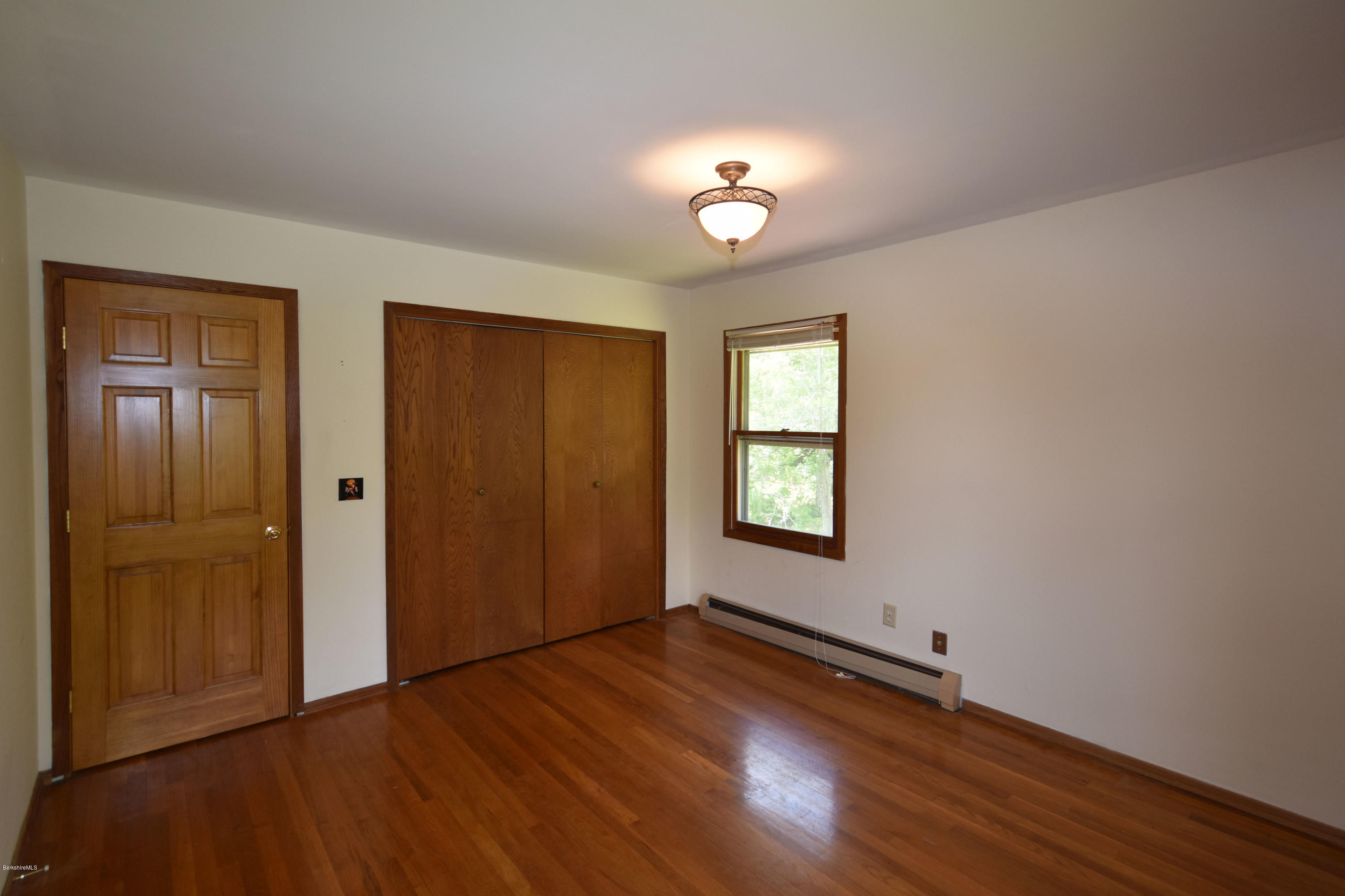 247 East Windsor Road Peru, MA 01235 - Photo 28 of 42 a view of an empty room with wooden floor and a window