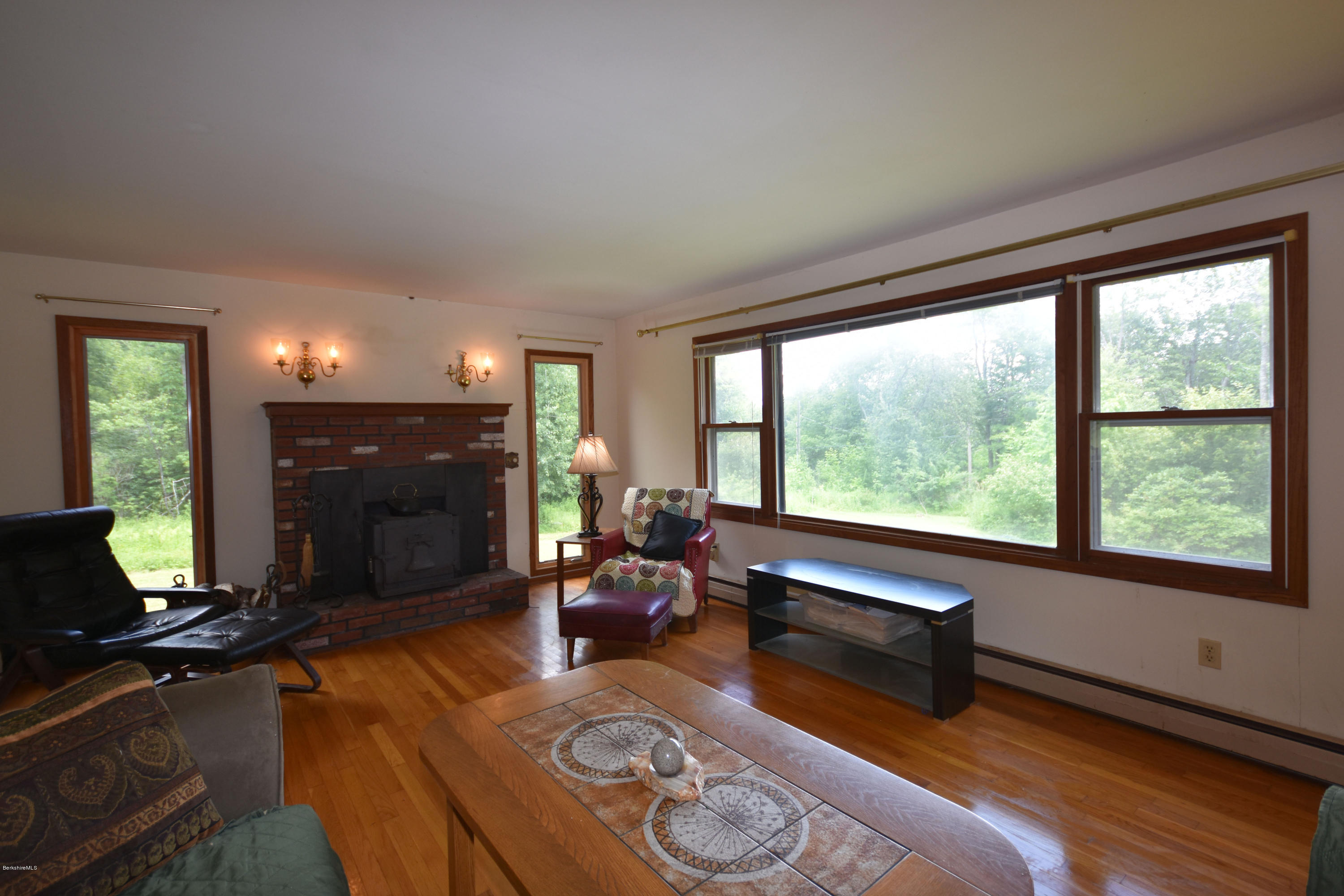 247 East Windsor Road Peru, MA 01235 - Photo 4 of 42 a living room with furniture fireplace and a large window