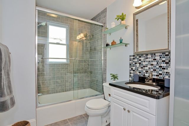 a bedroom with a bed and a wall painting