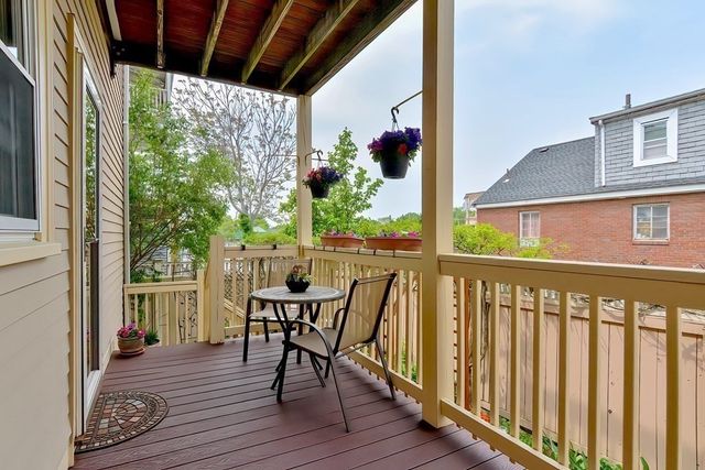 a view of a pathway of building with wooden fence