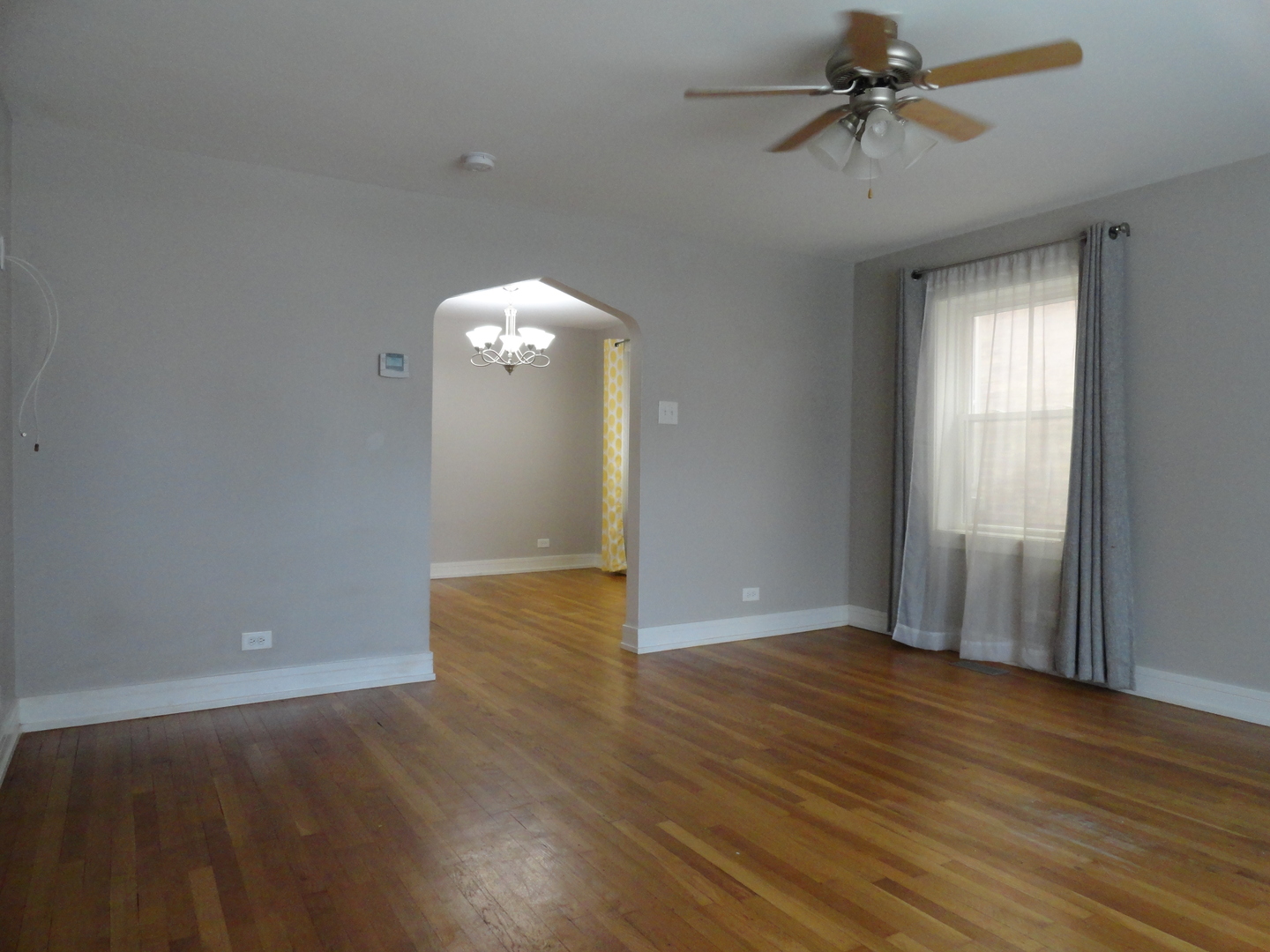 1410 Maple Avenue, Unit 1 Berwyn, IL 60402 - Photo 3 of 15 wooden floor in an empty room with a window