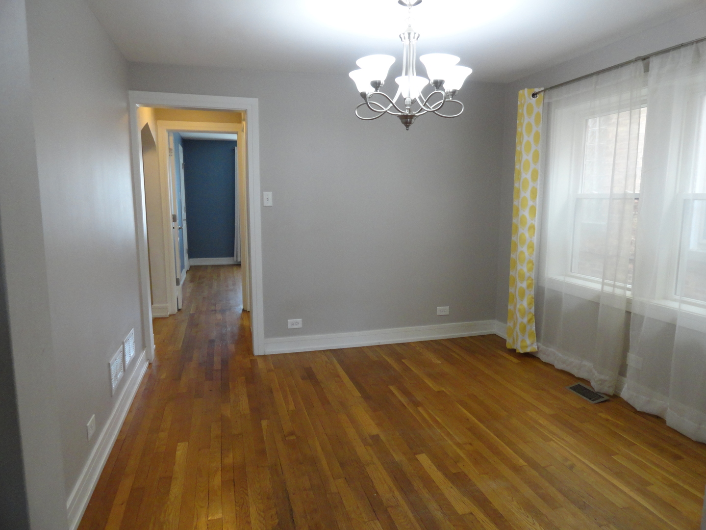 1410 Maple Avenue, Unit 1 Berwyn, IL 60402 - Photo 4 of 15 wooden floor in an empty room with a window
