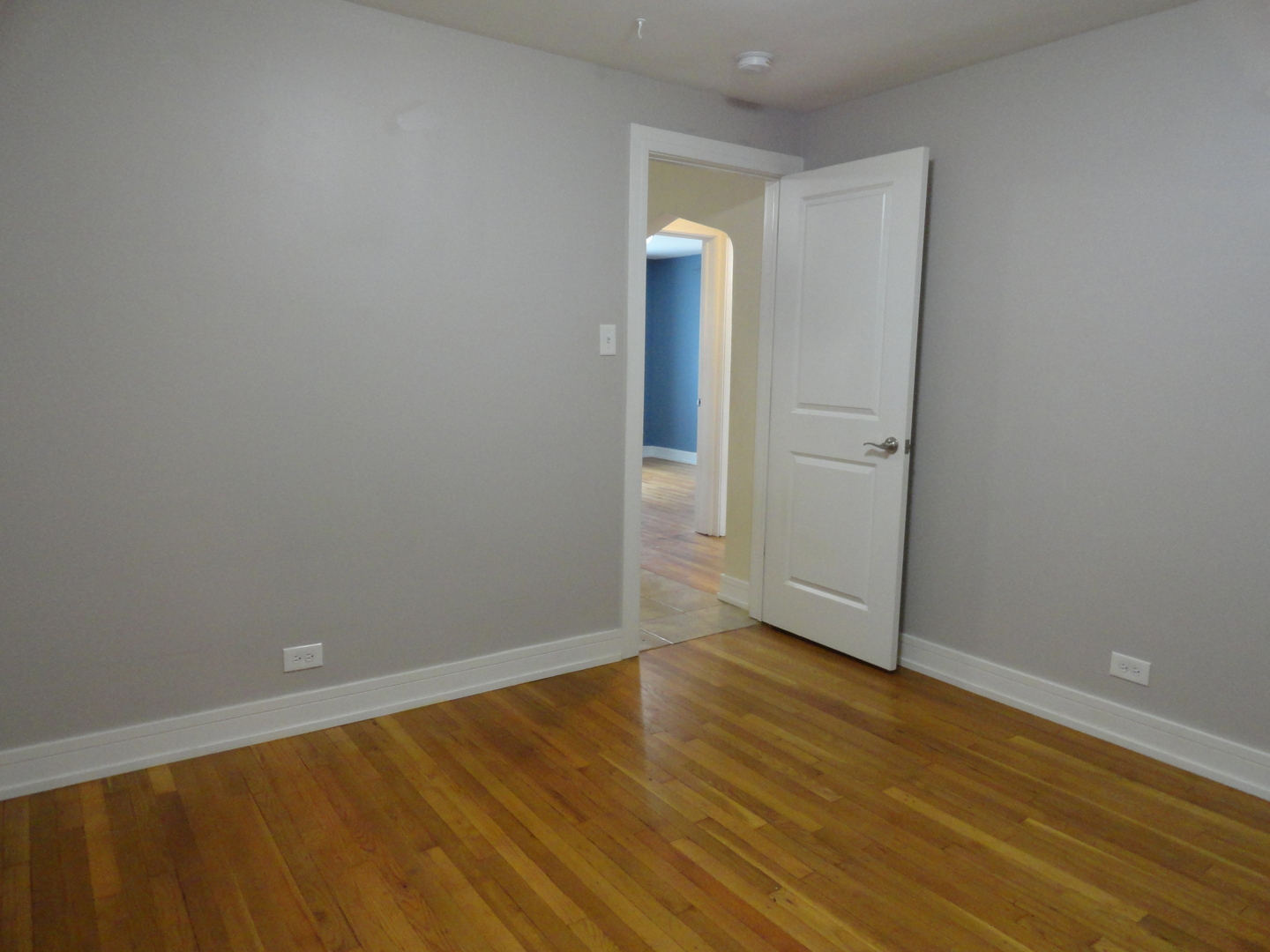 1410 Maple Avenue, Unit 1 Berwyn, IL 60402 - Photo 8 of 15 a view of an empty room with wooden floor and a window