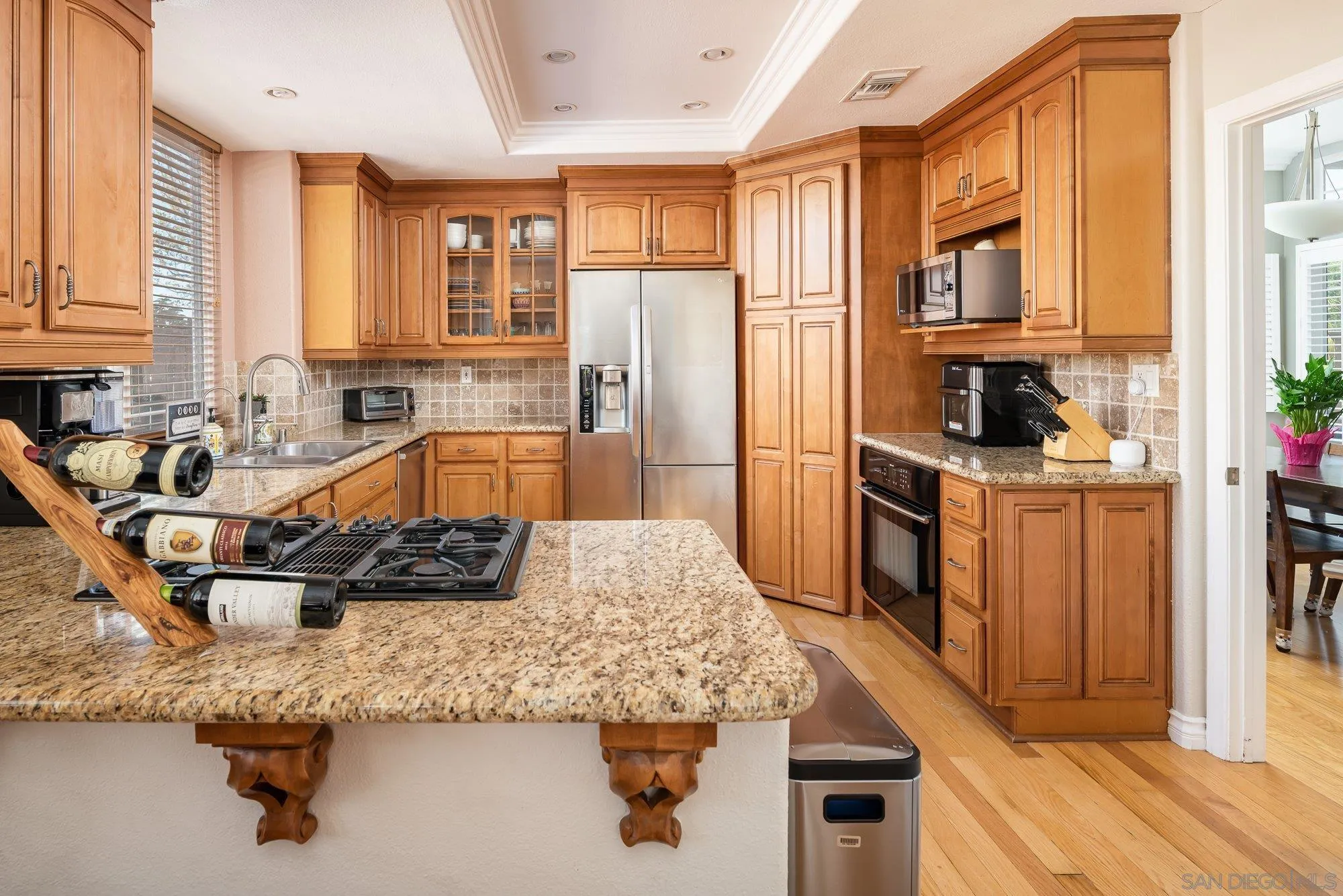 657 Cantara Lane Vista, CA 92081 - Photo 12 of 61 a kitchen with stainless steel appliances granite countertop a sink stove and refrigerator