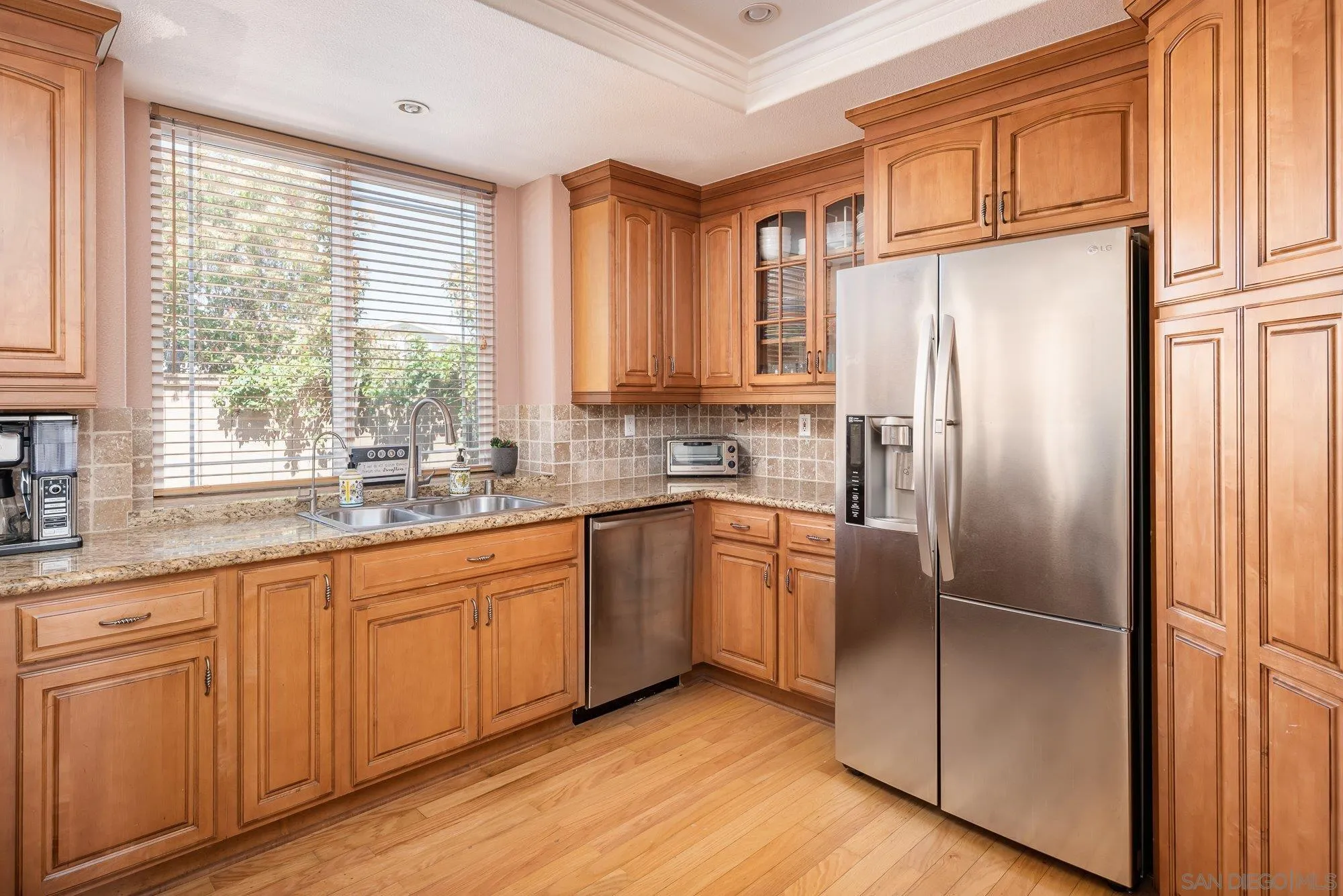 657 Cantara Lane Vista, CA 92081 - Photo 13 of 61 a kitchen with granite countertop stainless steel appliances a refrigerator cabinets and a window