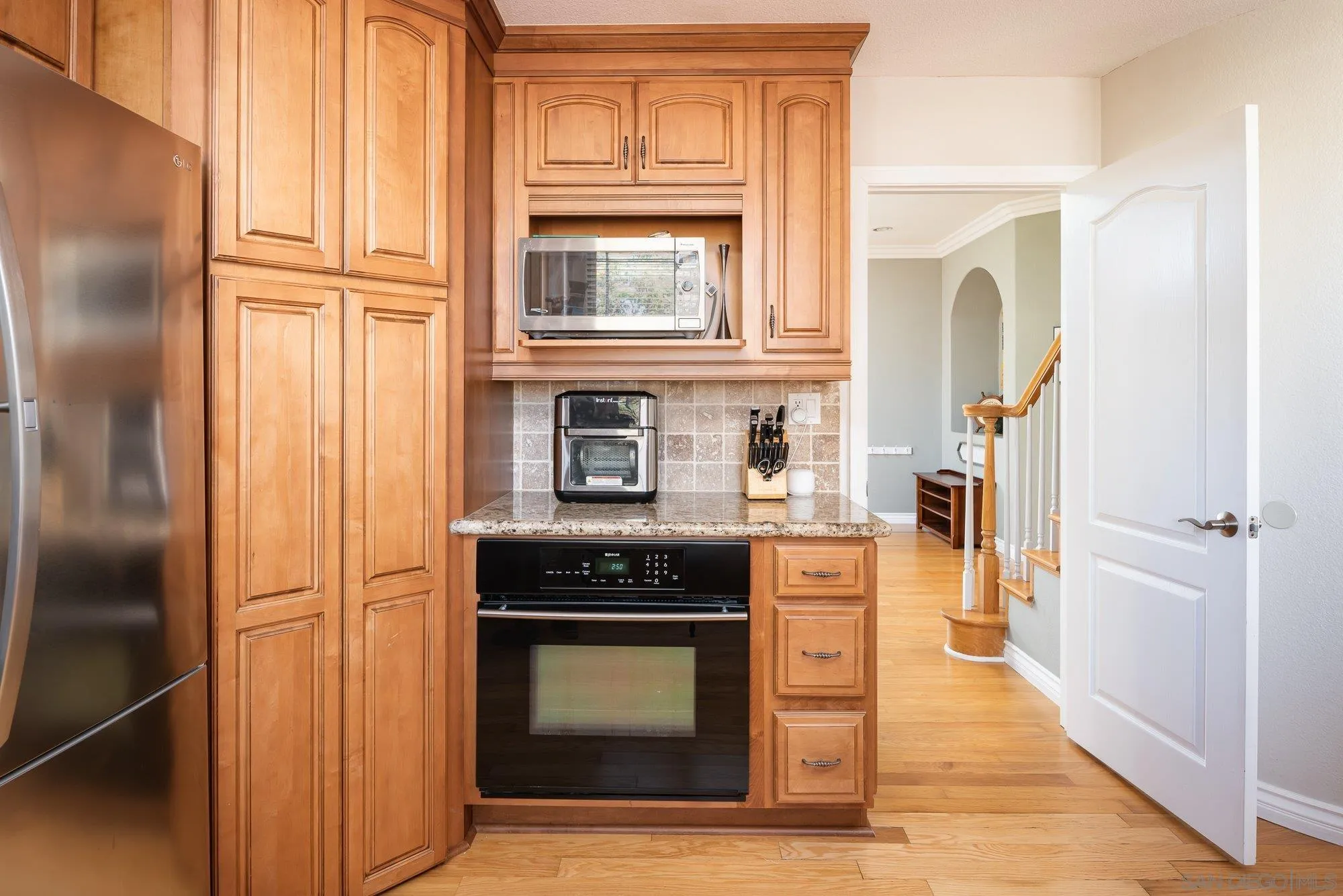 657 Cantara Lane Vista, CA 92081 - Photo 14 of 61 a kitchen with stainless steel appliances granite countertop a refrigerator and a stove top oven