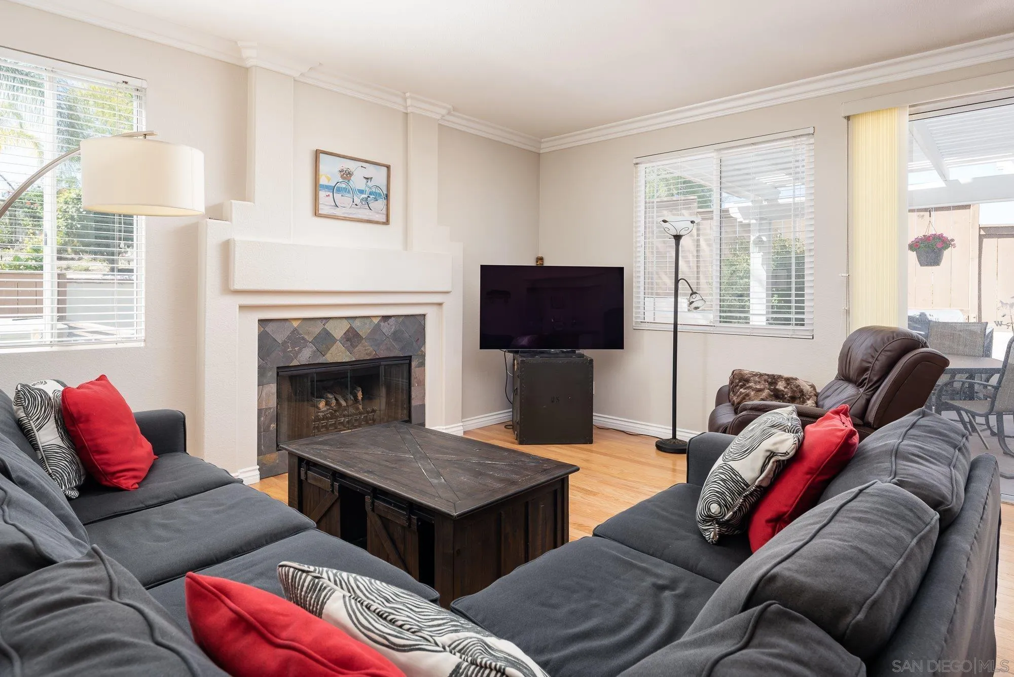 657 Cantara Lane Vista, CA 92081 - Photo 18 of 61 a living room with furniture a flat screen tv and a fireplace
