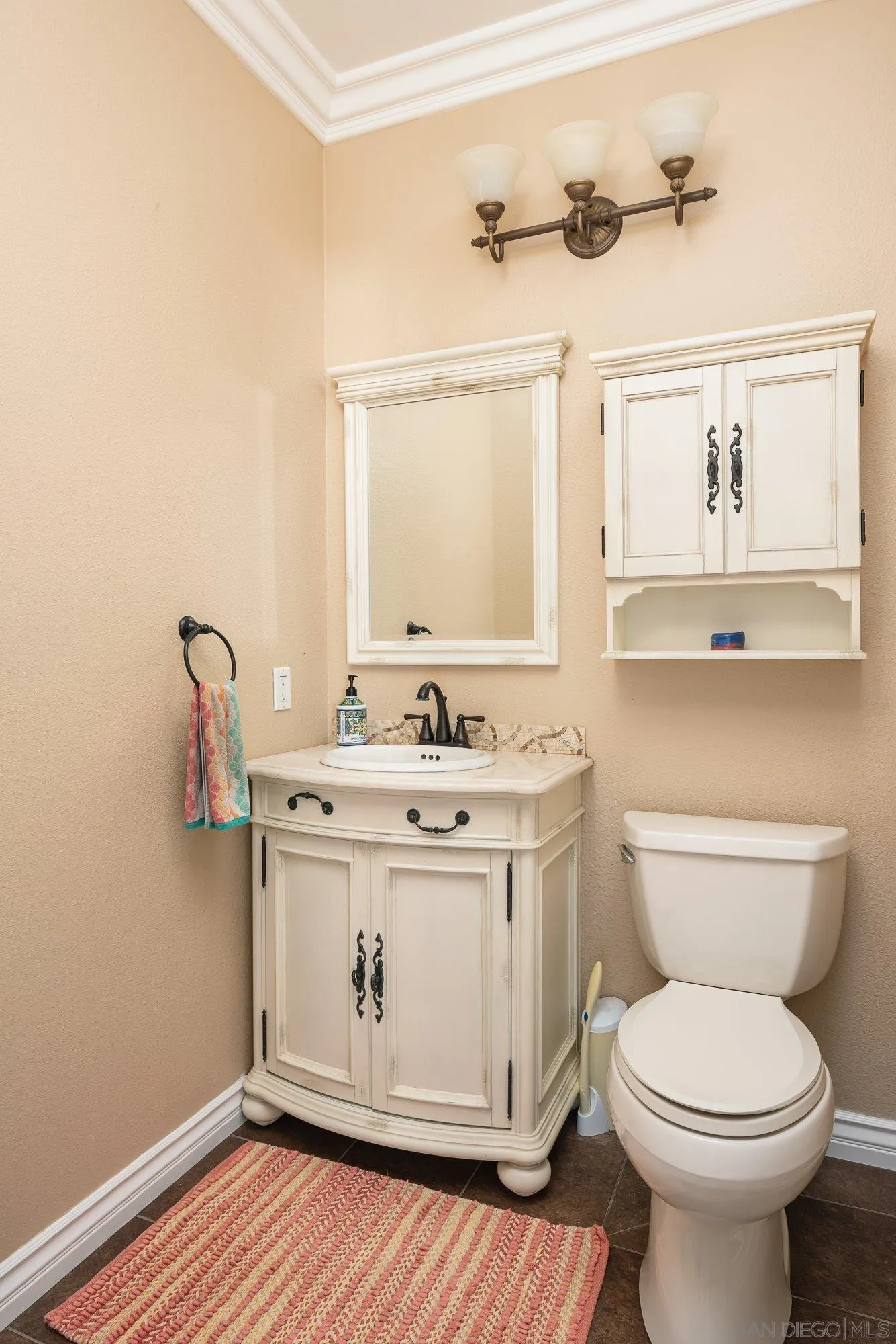 657 Cantara Lane Vista, CA 92081 - Photo 21 of 61 a bathroom with a granite countertop toilet sink and mirror