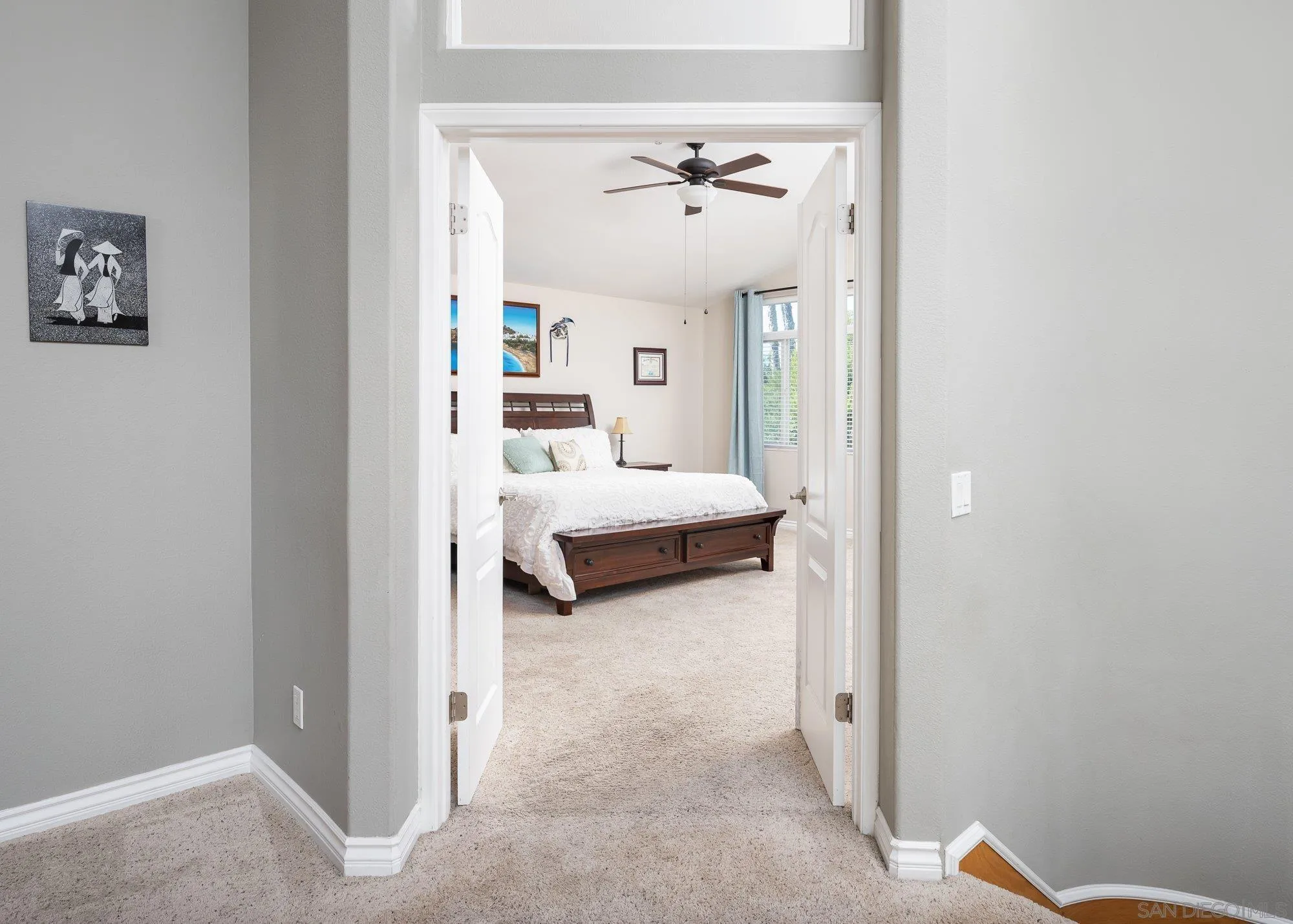 657 Cantara Lane Vista, CA 92081 - Photo 29 of 61 a bedroom with a bed and a chandelier