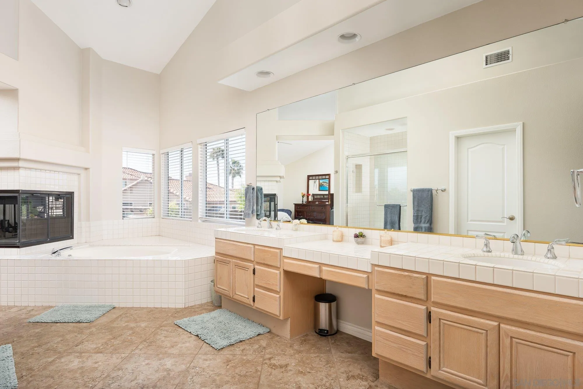 657 Cantara Lane Vista, CA 92081 - Photo 34 of 61 a bathroom with a tub sink and a mirror