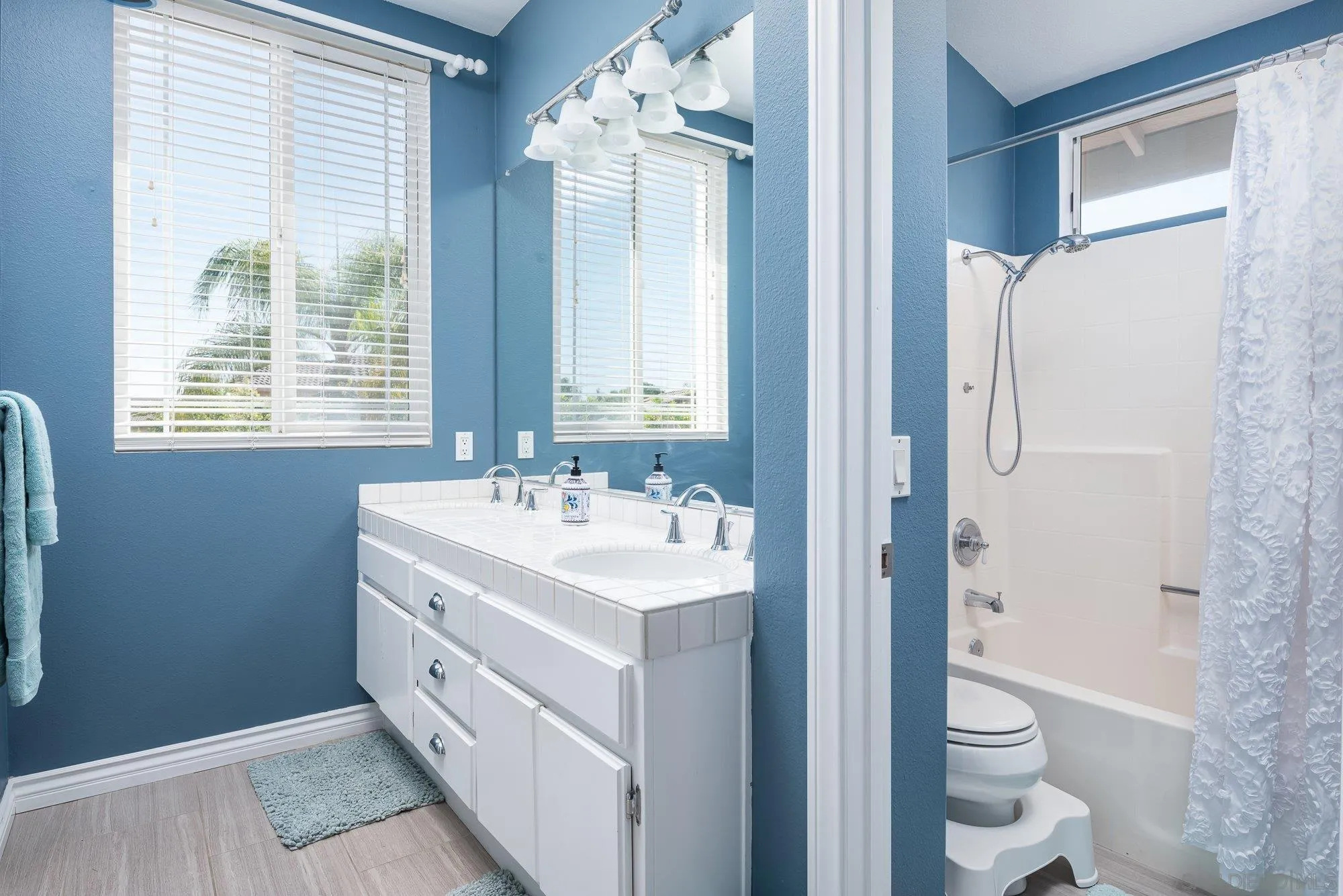 657 Cantara Lane Vista, CA 92081 - Photo 37 of 61 a bathroom with a double vanity sink toilet and shower