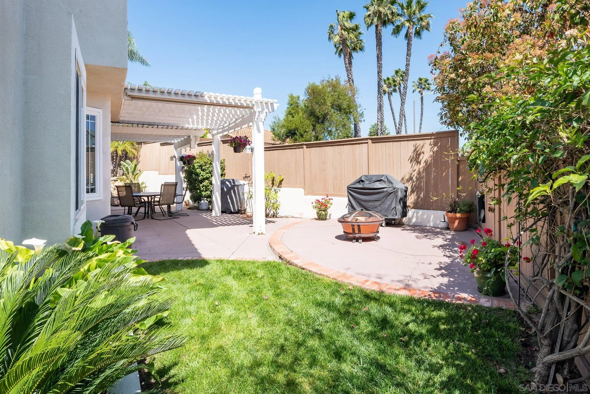 657 Cantara Lane Vista, CA 92081 - Photo 41 of 61 a bench is sitting in the middle of a backyard
