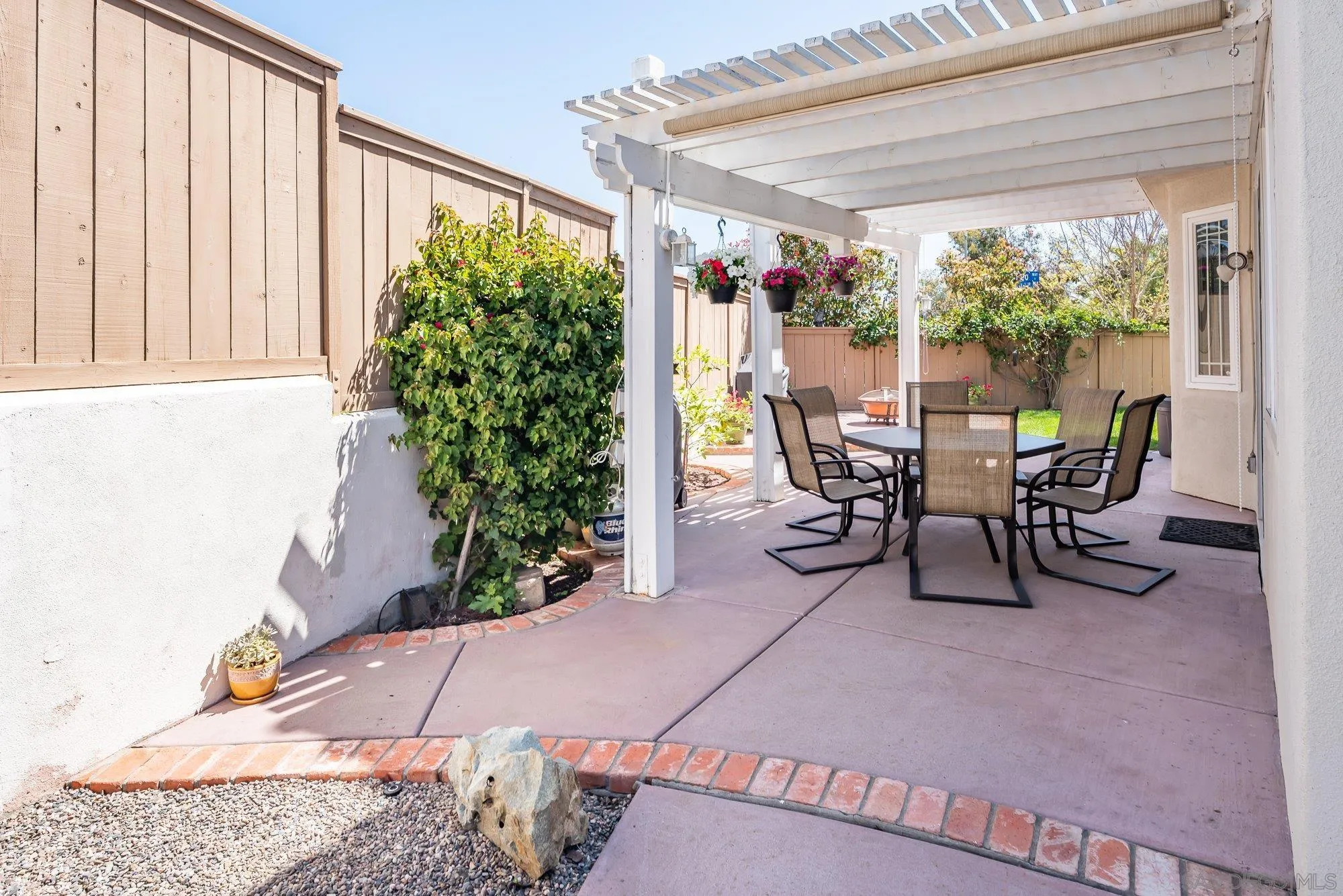 657 Cantara Lane Vista, CA 92081 - Photo 47 of 61 a view of a patio with table and chairs and potted plants