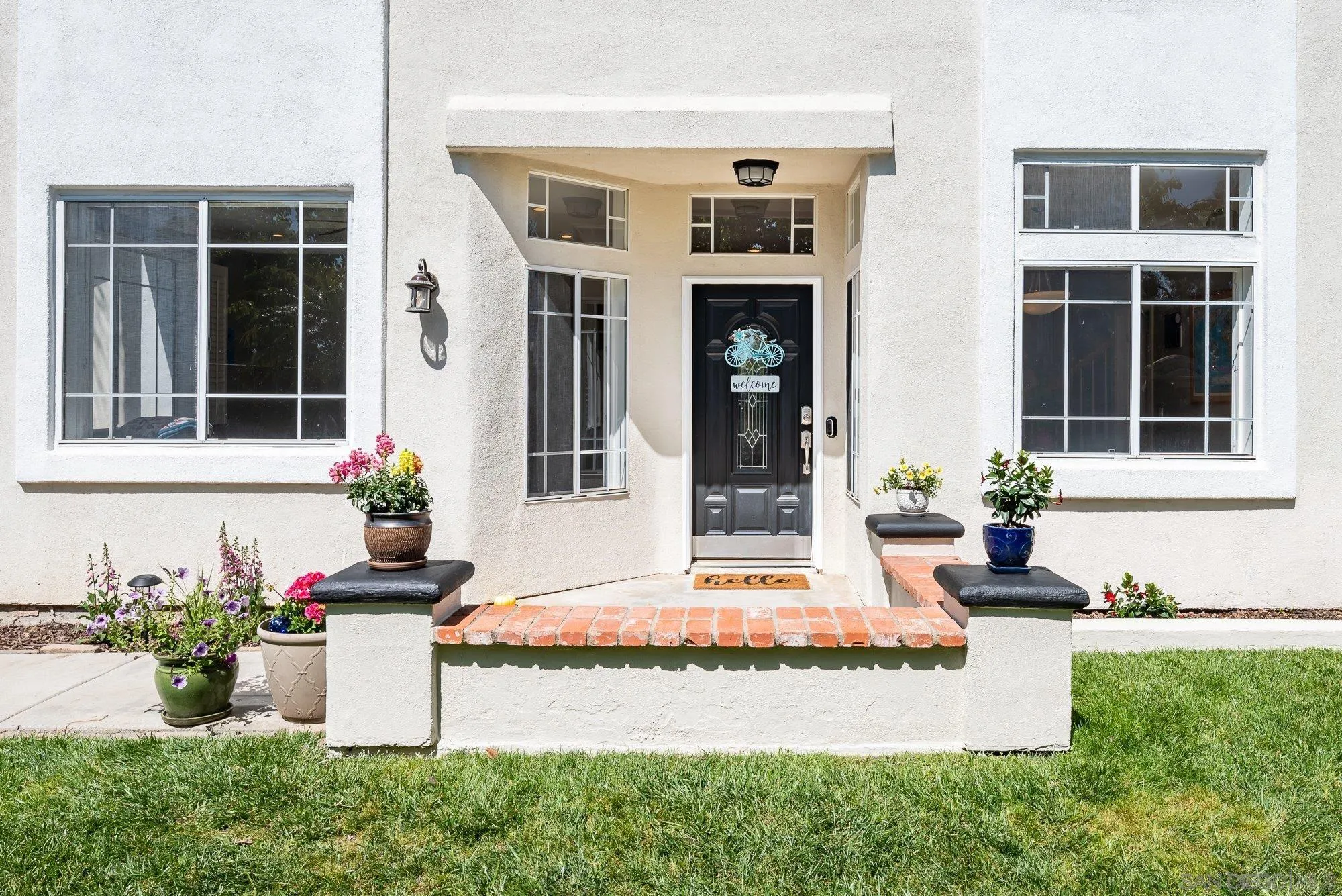 657 Cantara Lane Vista, CA 92081 - Photo 5 of 61 front view of a house with potted plants