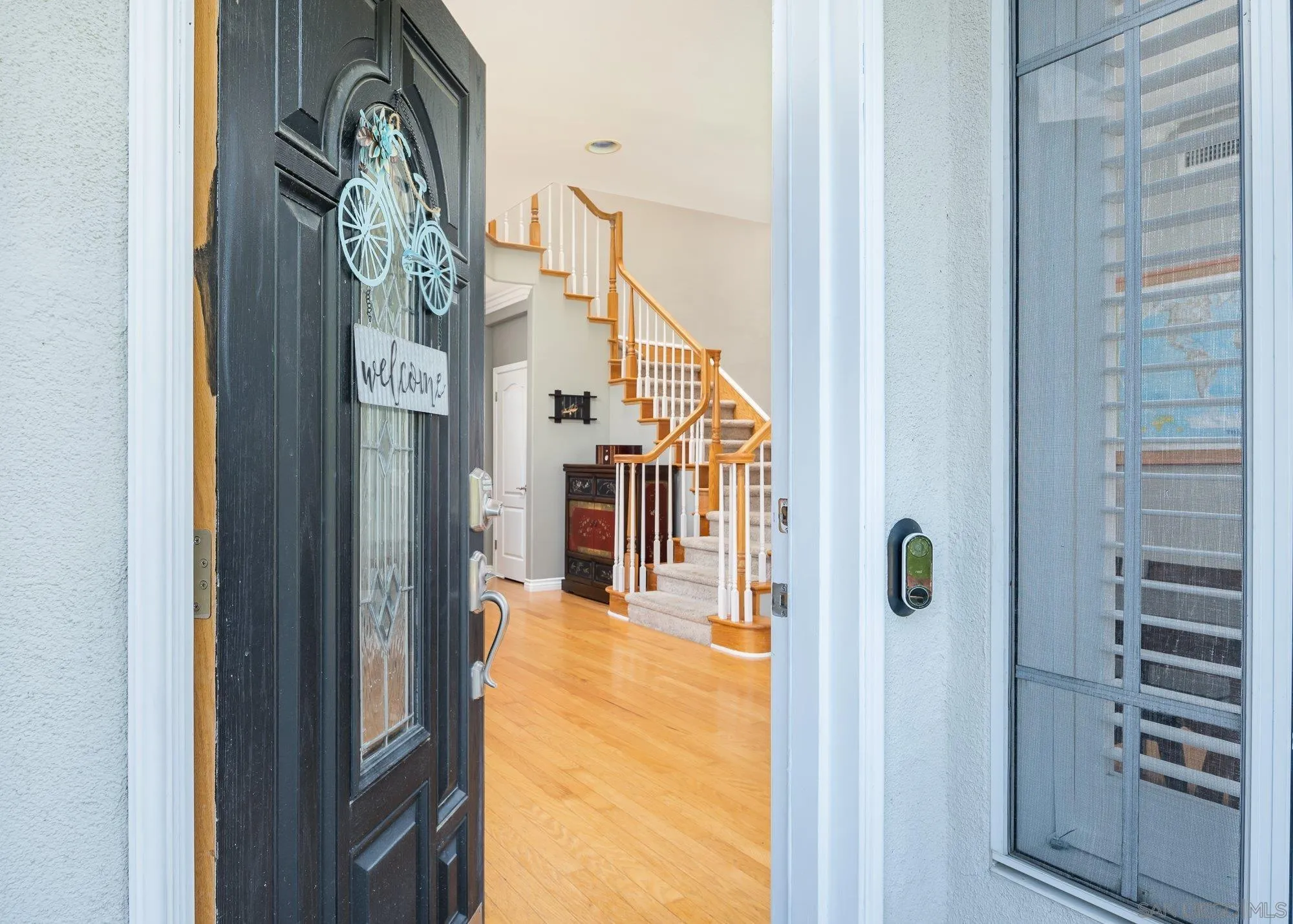 657 Cantara Lane Vista, CA 92081 - Photo 6 of 61 a view of a hallway with wooden floor and entryway