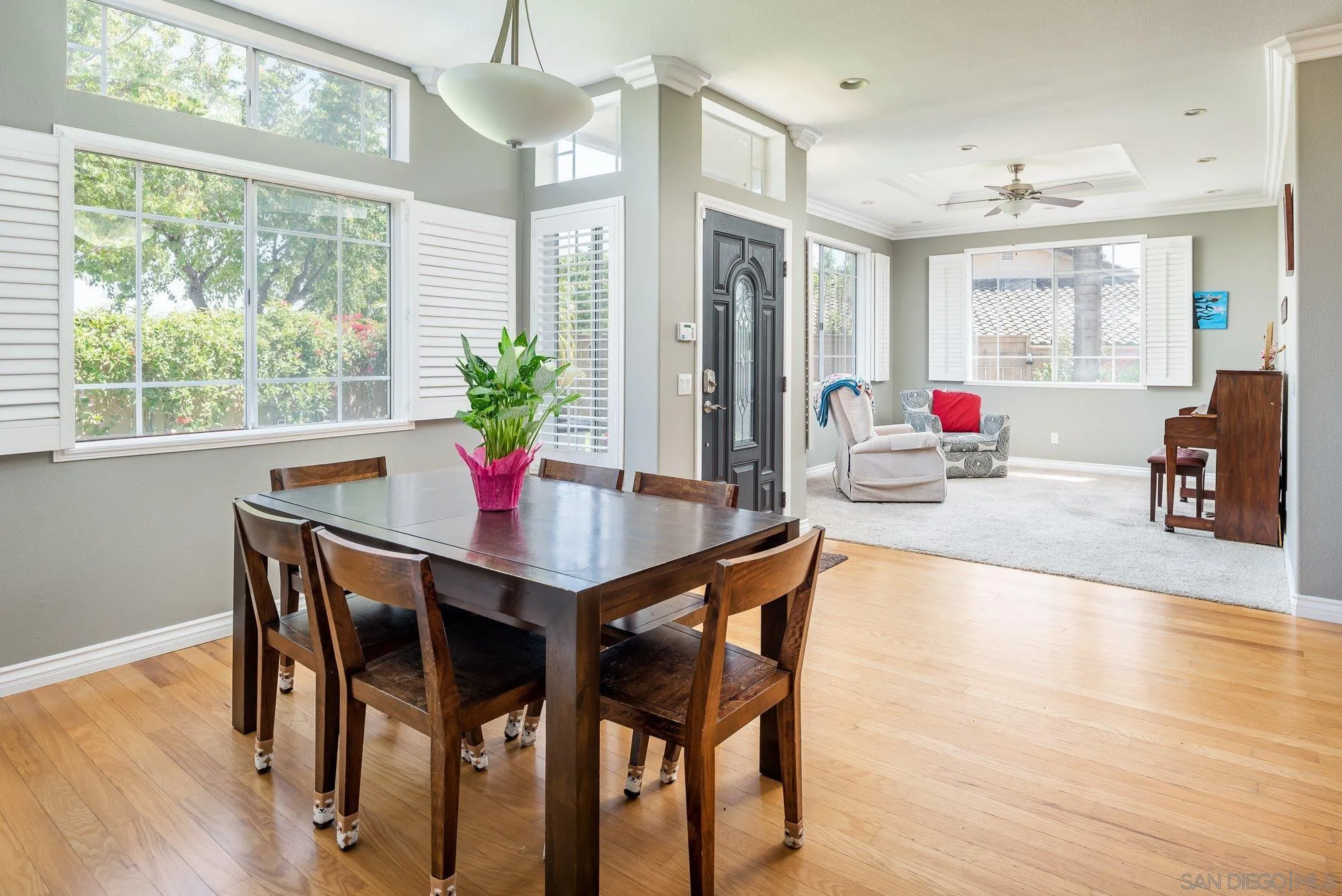 657 Cantara Lane Vista, CA 92081 - Photo 7 of 61 a view of a dining room and livingroom with furniture wooden floor and a chandelier