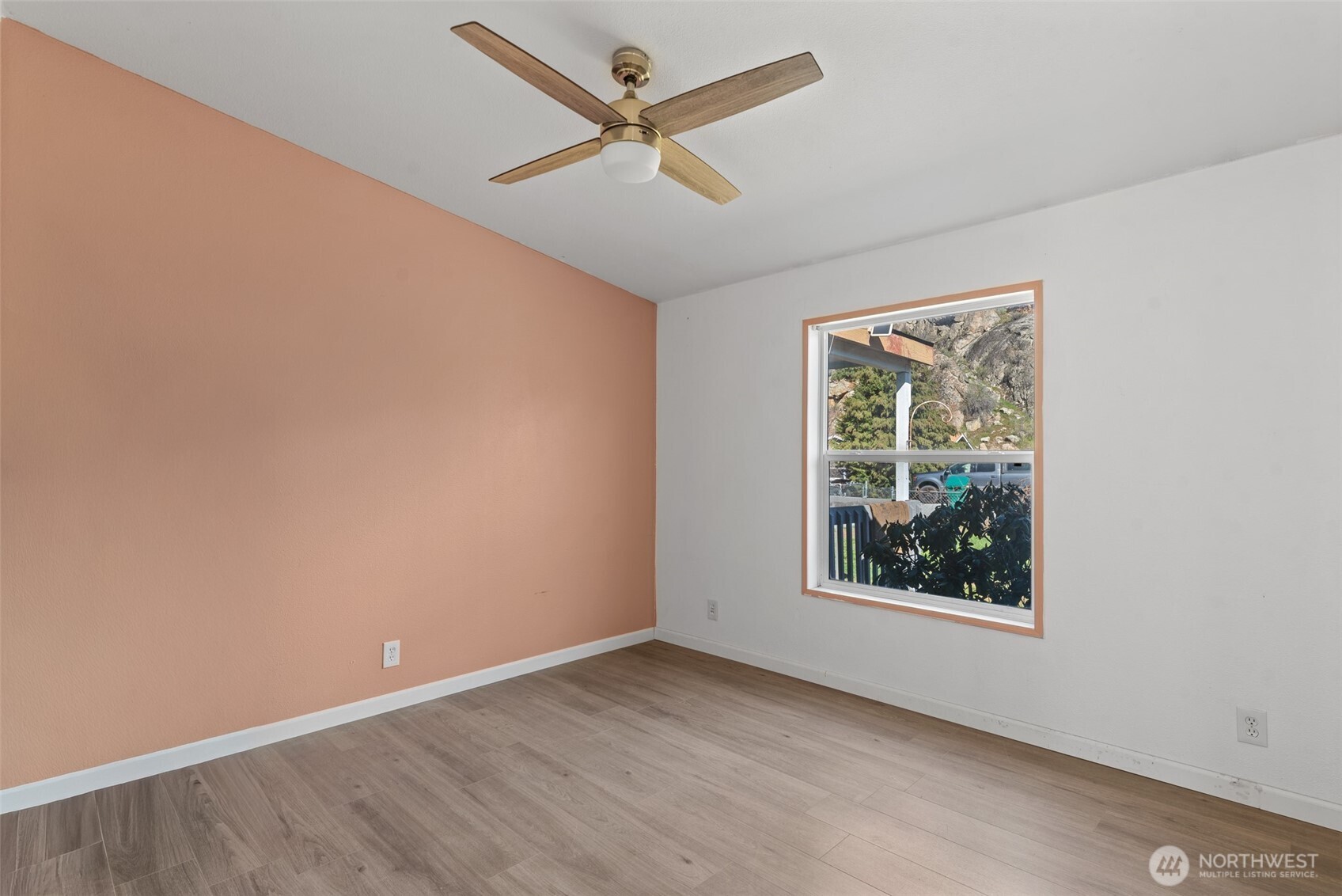 14934 Golden Delicious Street Entiat, WA 98822 - Photo 23 of 33 an empty room with a window and a ceiling fan