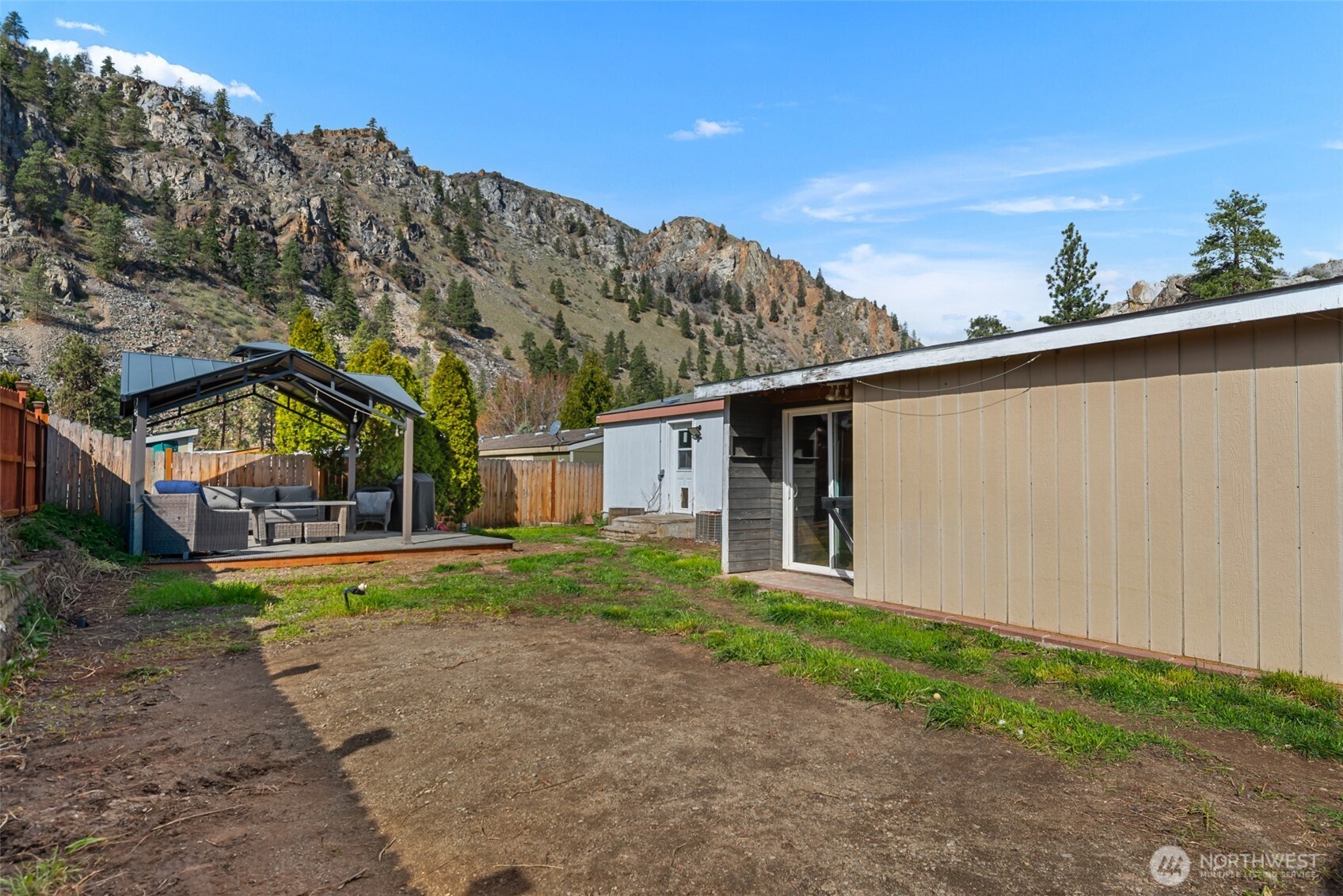 14934 Golden Delicious Street Entiat, WA 98822 - Photo 28 of 33 a view of a big house with a big yard and potted plants