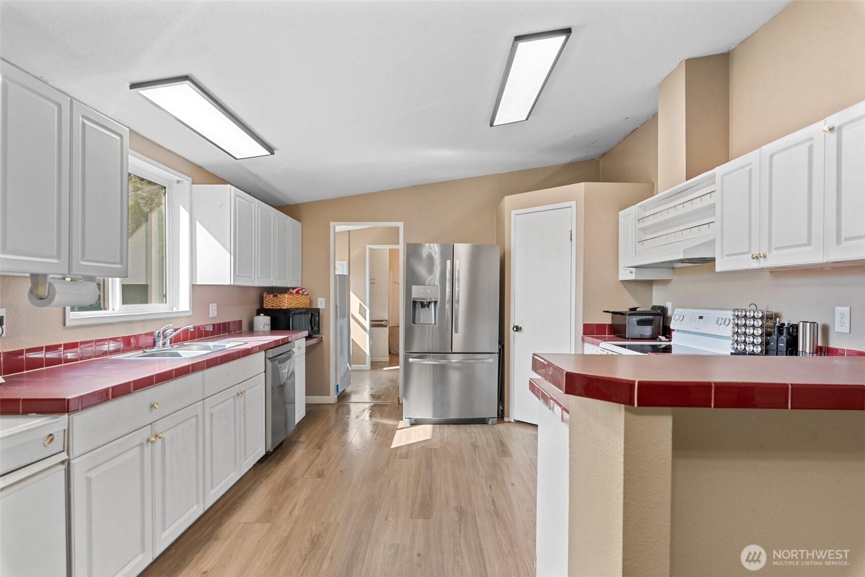 14934 Golden Delicious Street Entiat, WA 98822 - Photo 9 of 33 a kitchen with refrigerator cabinets and wooden floor