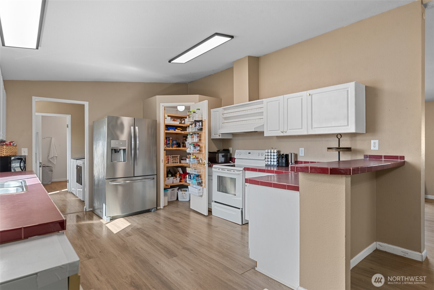 14934 Golden Delicious Street Entiat, WA 98822 - Photo 10 of 33 a kitchen with stainless steel appliances a stove refrigerator sink and cabinets